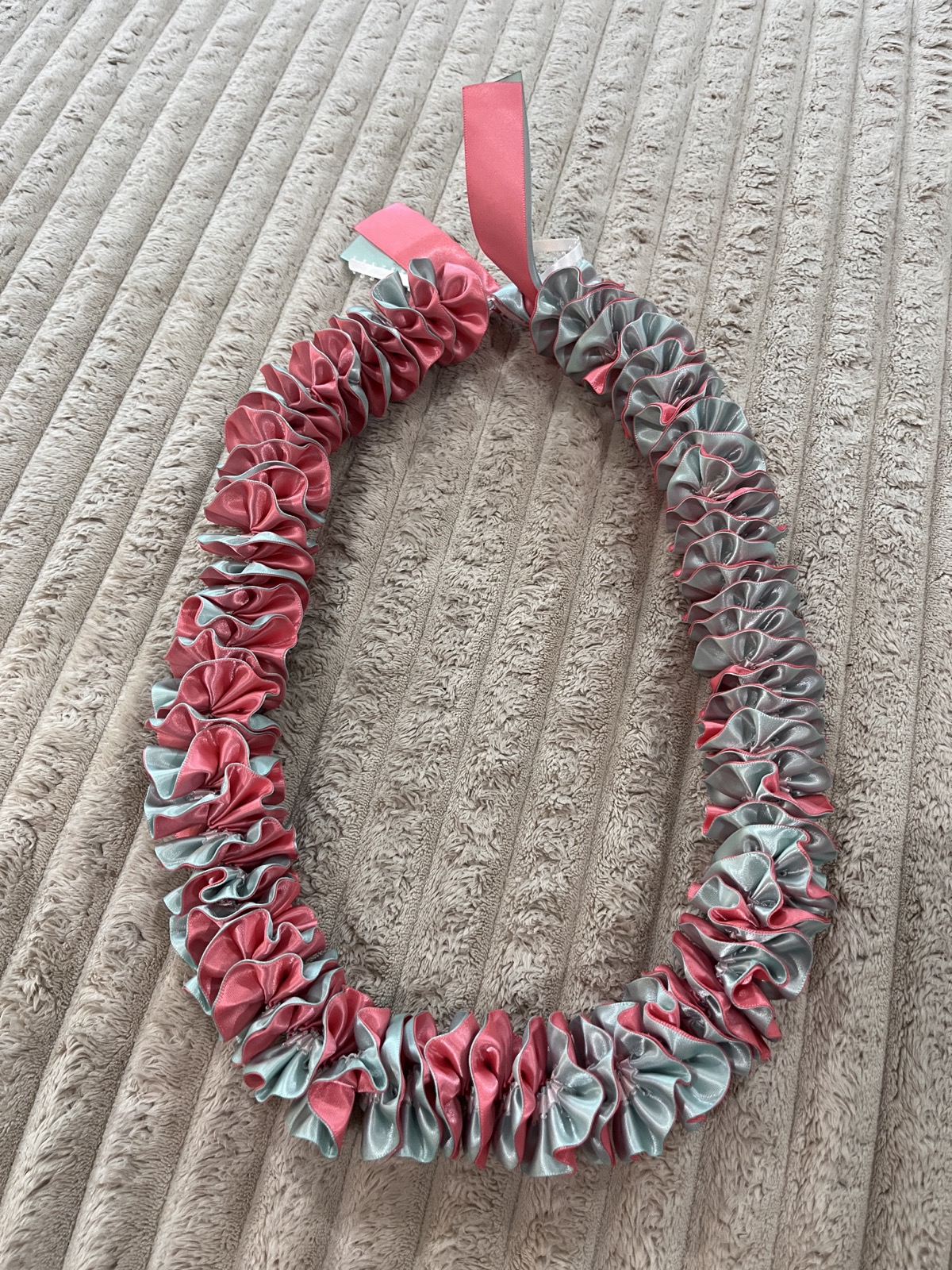 Pink and silver ruffled ribbon lei